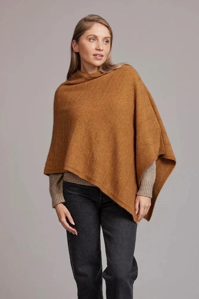 5007 Garter Detail Poncho - Elegance made easy with this garter detail.  Featuring diagonal garter detail and an asymmetric neck line, this piece is versatile and stylish.  35% Possum Fur, 55% Merino Wool, 10% Pure Mulberry Silk New Zealand designed and made Natural and sustainable One Size fits most