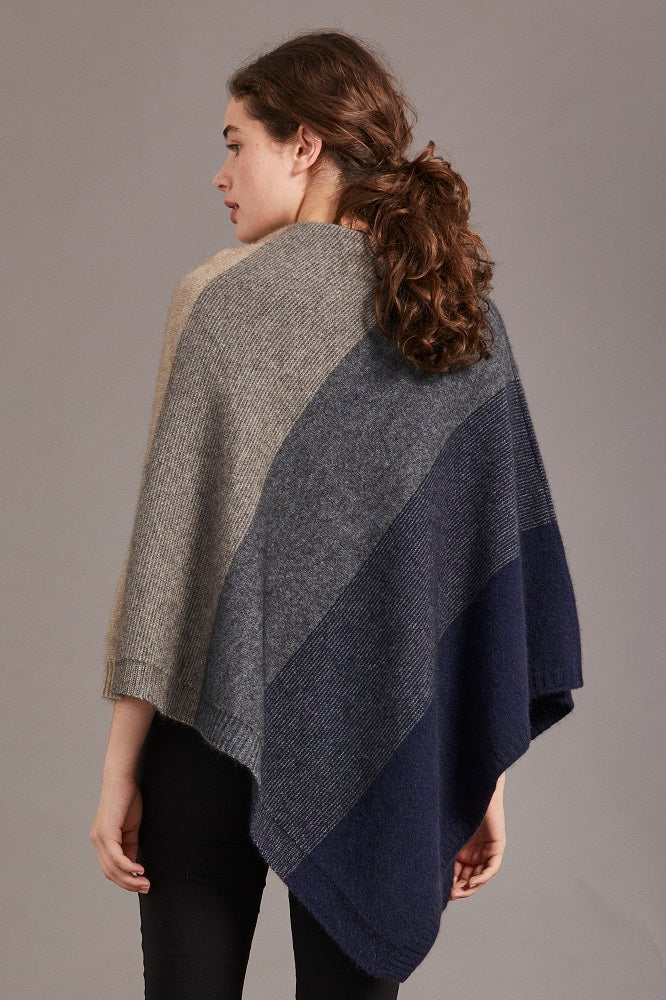 Possum and Merino

5010 Ombre Poncho - Our signature Ombre Poncho is available in five beautiful colour combinations. The incredible drape and classic style of this poncho will make it your go-to piece whenever there is a chill in the air.

Ombre Colour Pattern front and back
Mid-weight Warmth
35% Possum Fur, 55% Merino Wool, 10% Pure Mulberry Silk
New Zealand Designed and Manufactured

Natural and Sustainable
One Size Fits Most
Approximate size: Width 78 cm Length 66 cm.