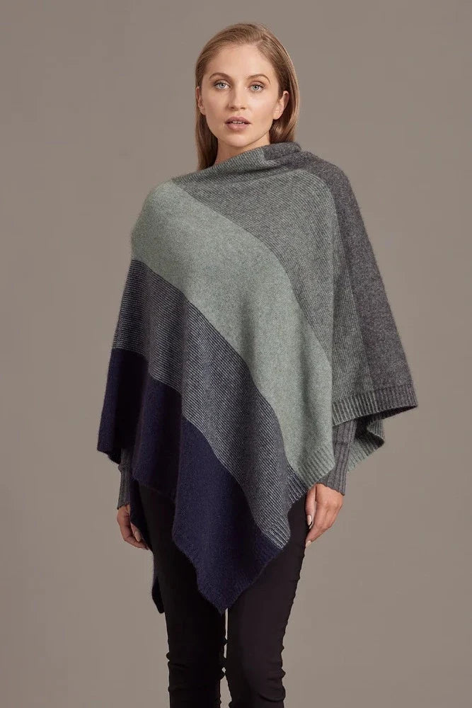 Possum and Merino

5010 Ombre Poncho - Our signature Ombre Poncho is available in five beautiful colour combinations. The incredible drape and classic style of this poncho will make it your go-to piece whenever there is a chill in the air.

Ombre Colour Pattern front and back
Mid-weight Warmth
35% Possum Fur, 55% Merino Wool, 10% Pure Mulberry Silk
New Zealand Designed and Manufactured

Natural and Sustainable
One Size Fits Most
Approximate size: Width 78 cm Length 66 cm.