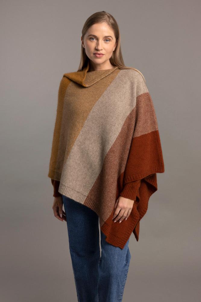 Possum and Merino

5010 Ombre Poncho - Our signature Ombre Poncho is available in five beautiful colour combinations. The incredible drape and classic style of this poncho will make it your go-to piece whenever there is a chill in the air.

Ombre Colour Pattern front and back
Mid-weight Warmth
35% Possum Fur, 55% Merino Wool, 10% Pure Mulberry Silk
New Zealand Designed and Manufactured

Natural and Sustainable
One Size Fits Most
Approximate size: Width 78 cm Length 66 cm.