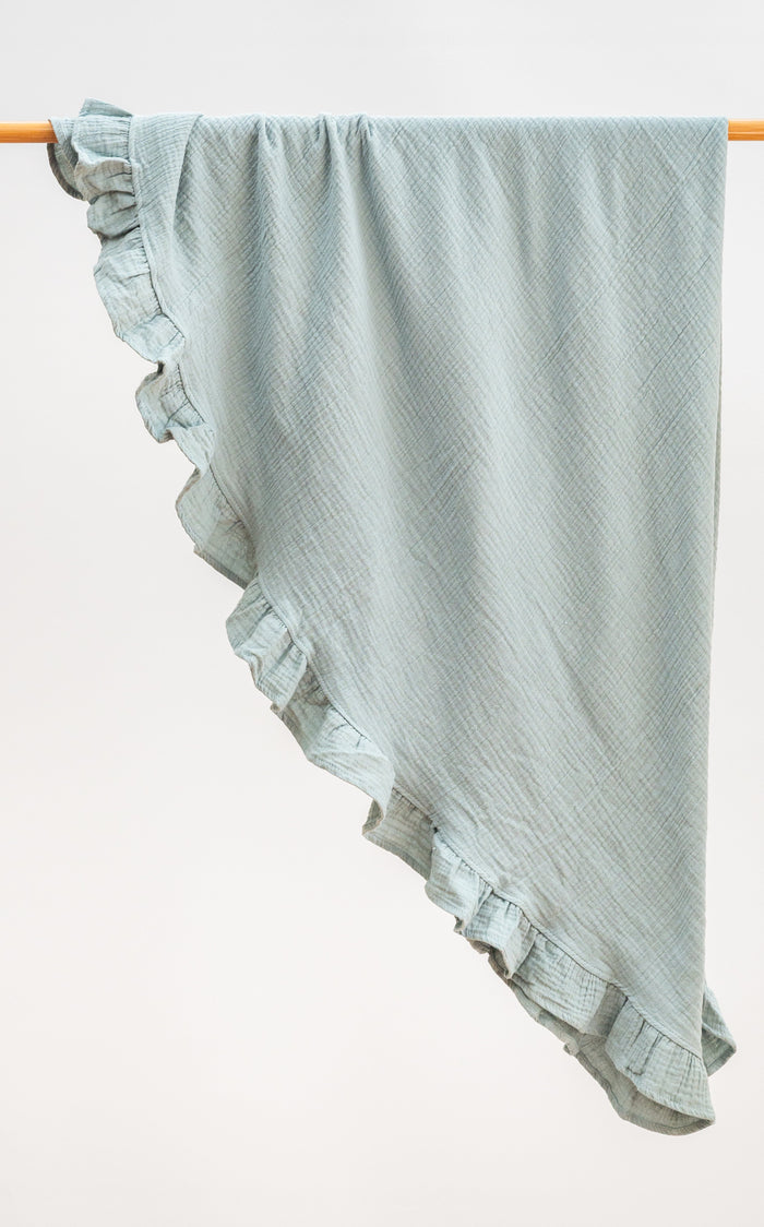 Lagoon green heirloom ruffle muslin baby blanket folded neatly, crafted from soft organic muslin with a ruffled border.