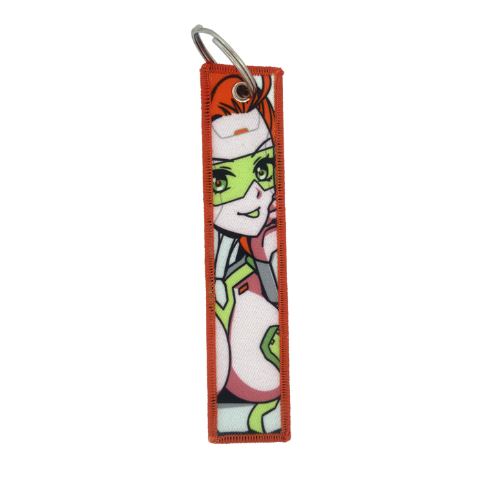 Keychain with a repeating design of a red-haired woman in a white and green futuristic suit with green glasses.