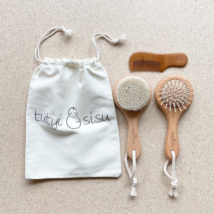 Baby brush and comb set packaged in keepsake pouch
