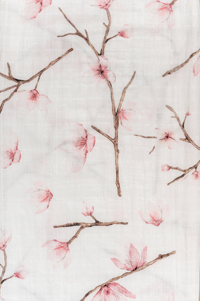 Cherry Blossom organic muslin swaddle in soft blush tones.