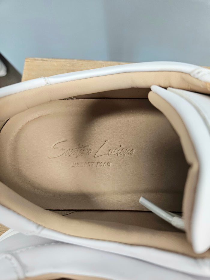 Inside of white faux leather sneakers for men.