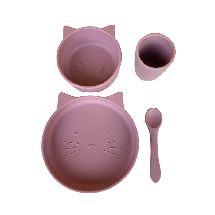 A four-piece baby and toddler dinnerware set in rose color, including a suction plate, suction bowl, spoon, and cup, each with a cat face design.