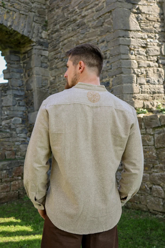 Back view of beige Celtic Shield Collarless Shirt with embroidered Celtic shield motif below the collar on Celtic clothing