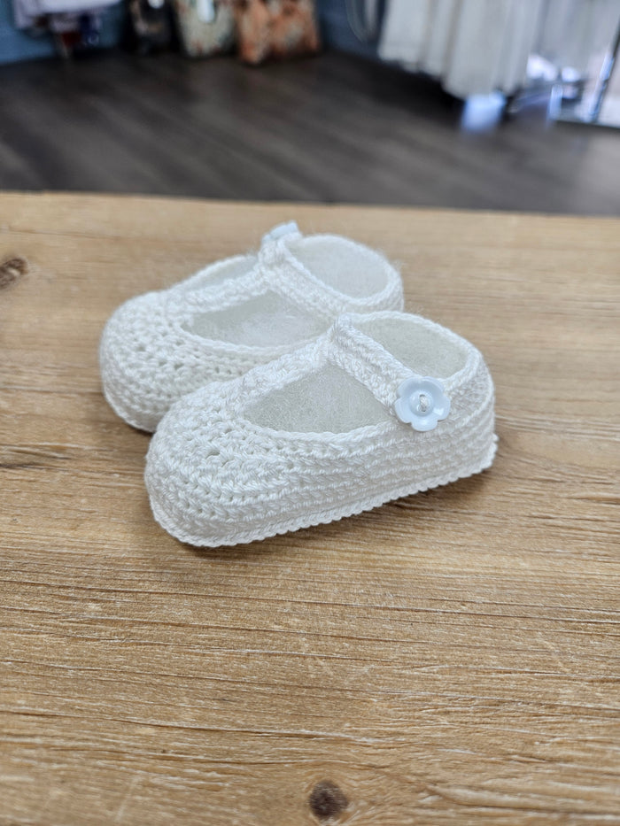 Crochet baby bootie with flower button.