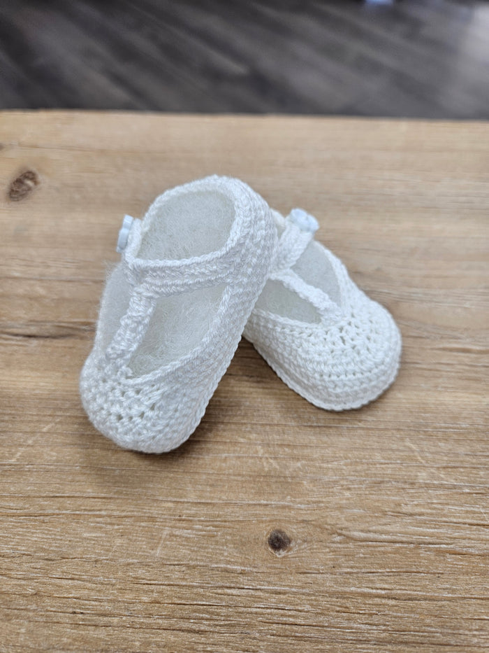 Crochet baby bootie with flower button.
