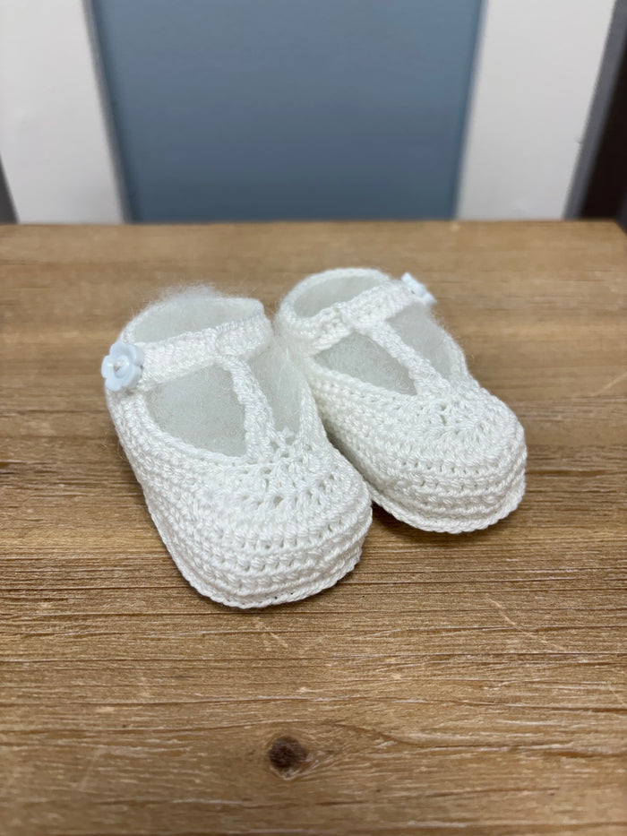 Crochet baby bootie with flower button.