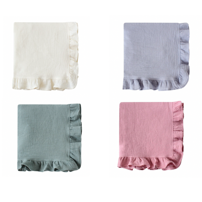 Heirloom ruffle muslin baby blankets folded neatly in ivory, blue, sage, and blush, made from soft organic muslin with delicate ruffle edges.