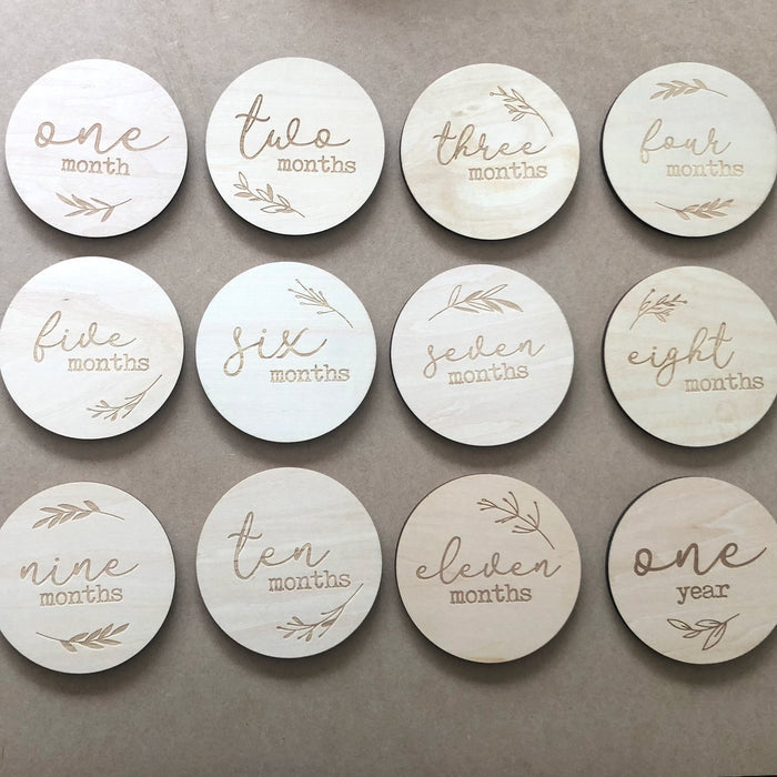 Double-sided wooden milestone cards with leaf design