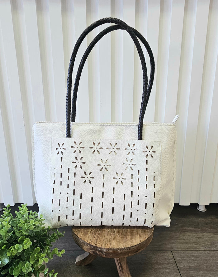 Leather tote bag with floral detail.