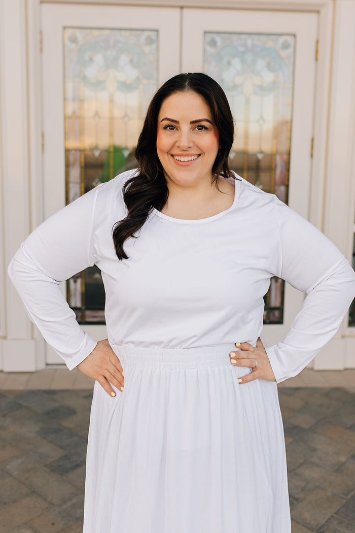 woman in long sleeved t-shirt and skirt
