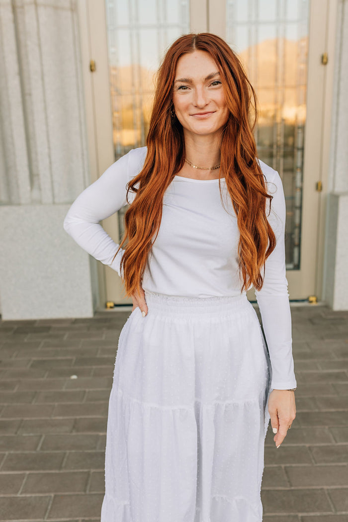woman in long sleeved tee and skirt