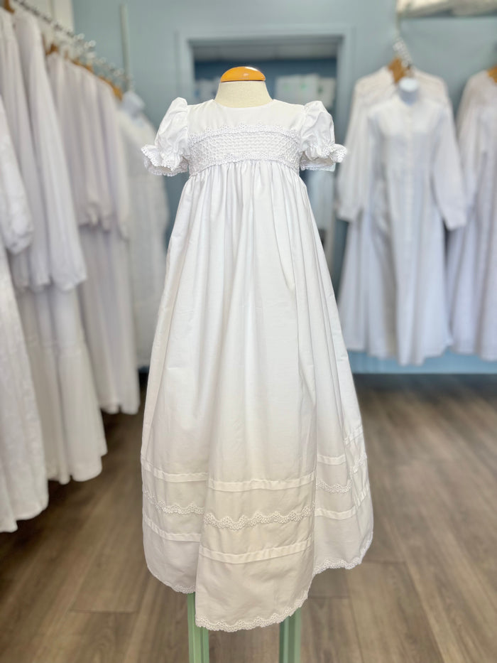 Long white cotton baby gown with stripes and smocking.