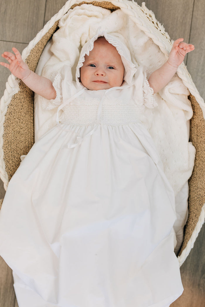 Long white cotton baby gown with stripes and smocking.