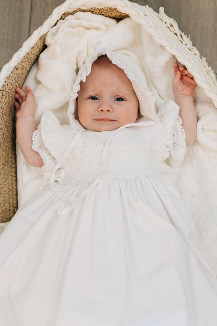 Long white cotton baby gown with stripes and smocking.