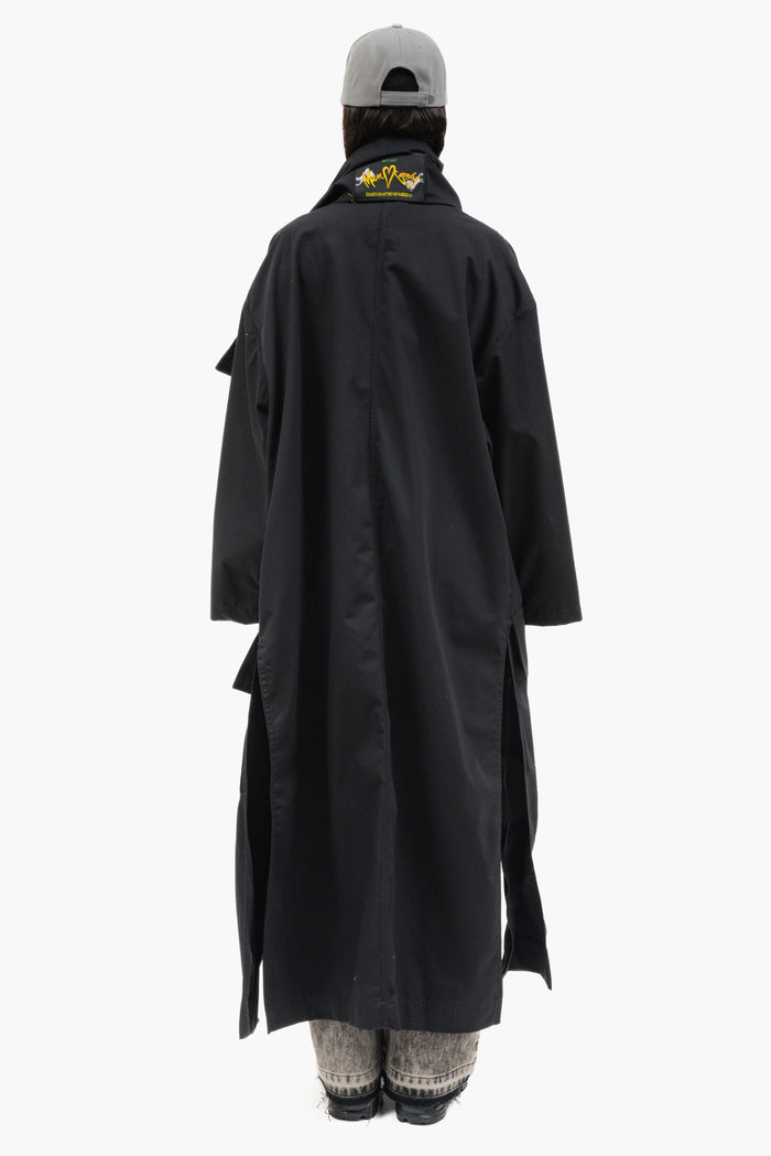 MANCANDY Nomad Trench in black cotton twill featuring a convertible scarf collar, oversized silhouette and multiple styling options.
