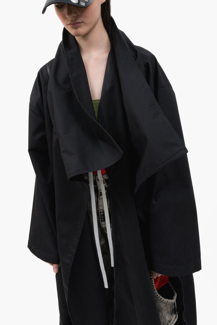 MANCANDY Nomad Trench in black cotton twill featuring a convertible scarf collar, oversized silhouette and multiple styling options.