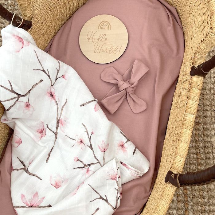 Birth announcement milestone card 'hello world' with headband and organic muslin swaddle.
