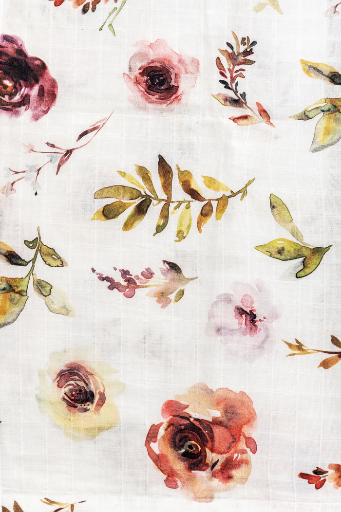 Lightweight organic cotton swaddle with botanical design