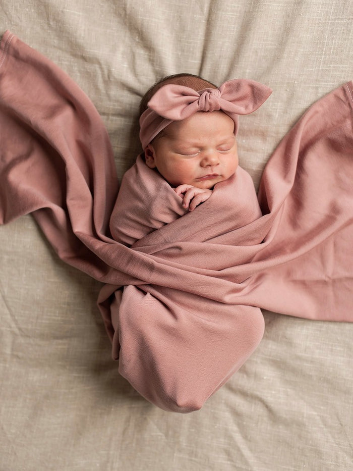 Organic jersey swaddle and topknot set in Rose Quartz, a gentle newborn essential designed for comfort and connection.