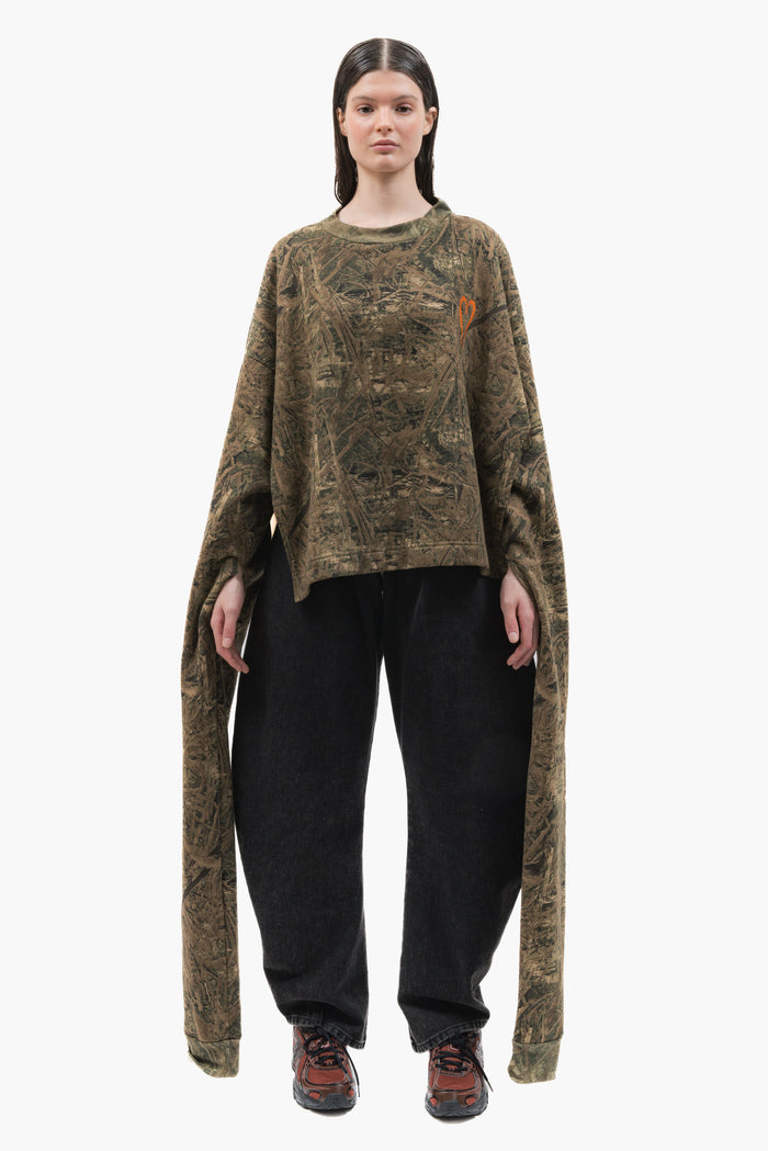 MANCANDY Poncho Sweatshirt Camo featuring camouflage print, embroidered heart logo, extra-long sleeves and open-sided poncho construction.