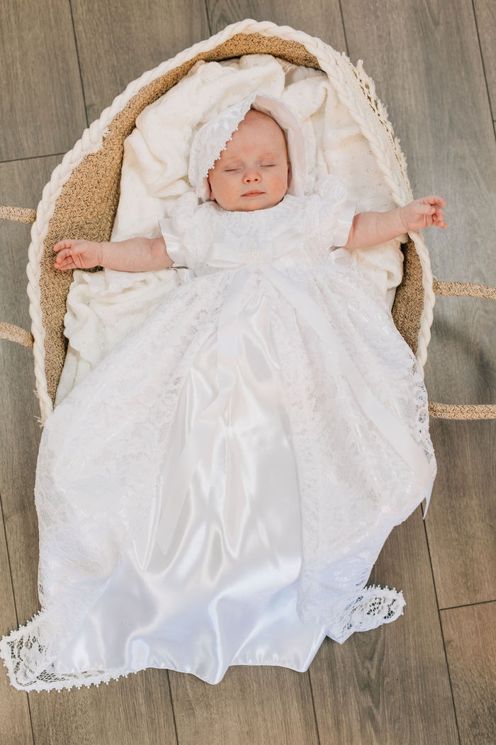 Long white lace and satin baby gown with bow.