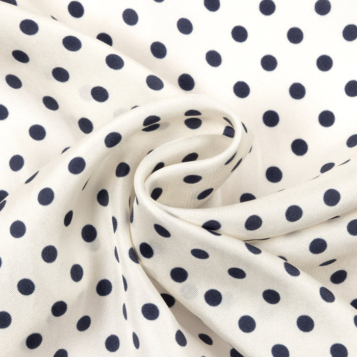 Navy blue square scarf with white polka dot pattern on a white background