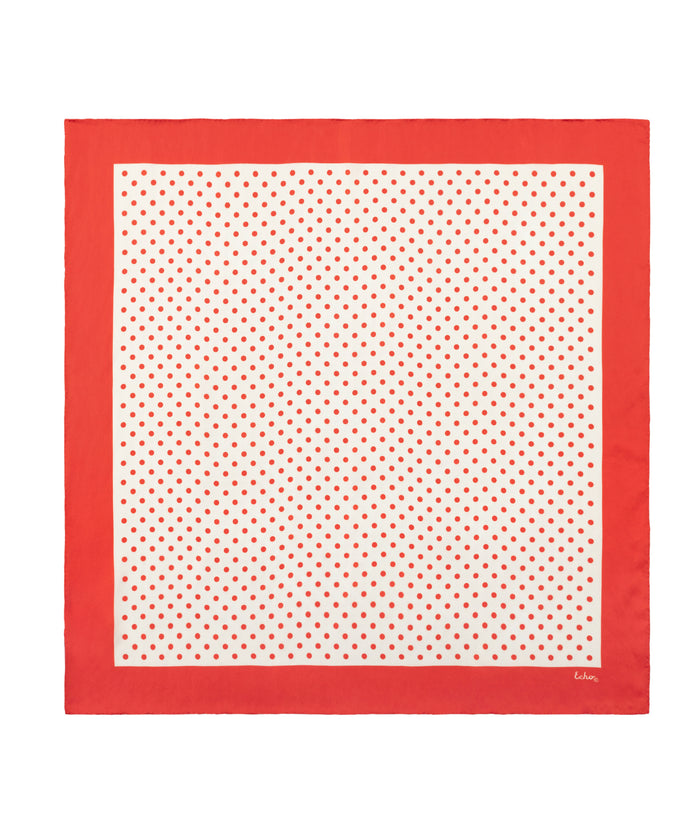 Red and white polka dot scarf on a white background