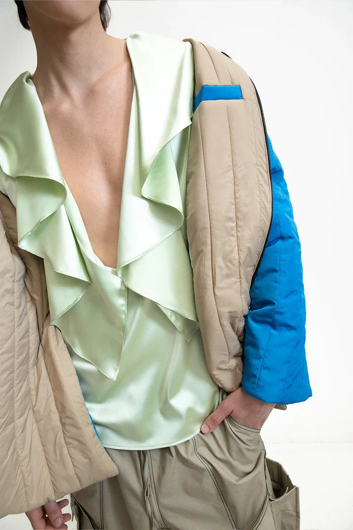 MANCANDY Utility Quilted Coat in blue nylon featuring oversized quilted construction, high side slits, contrast denim chest pocket, embroidered sleeve patch and front zip closure.