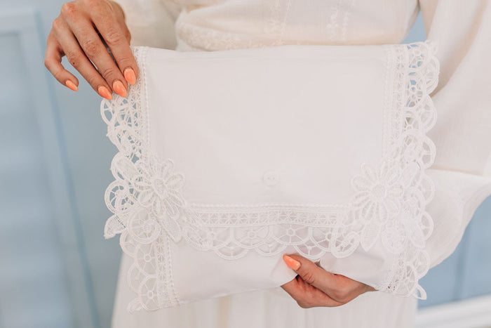 White cotton envelope with lace edges.