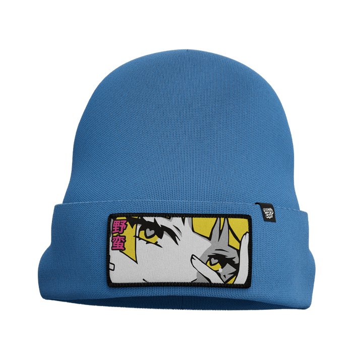Blue knit beanie with a folded cuff featuring a patch of an anime-style eye and pink Japanese characters.