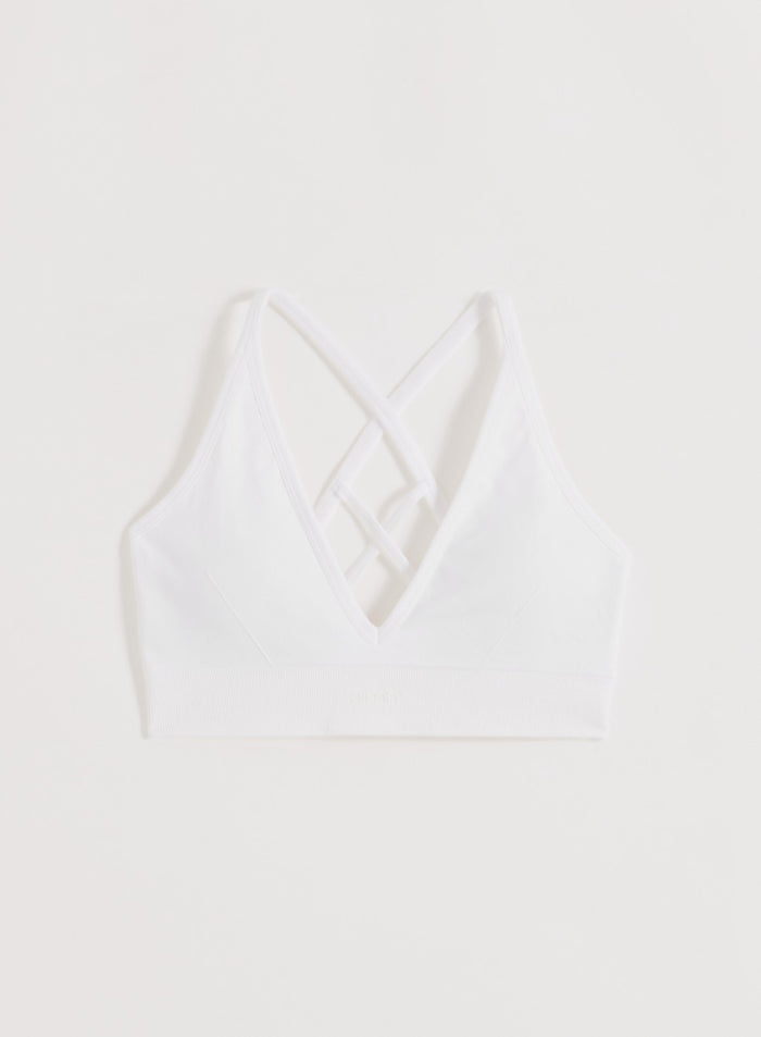 Valkoinen aim'n Shape Seamless Cross Back Bra ristiin menevillä selkäolkaimilla ja ribatulla alareunalla.