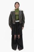 MANCANDY Wide Aviator Jacket in crackled black leather featuring a detachable shearling collar, oversized fit and curved sleeves.