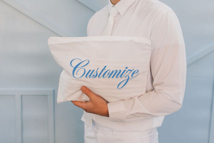 White zipper top envelope with customized embroidery.